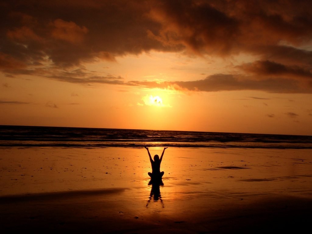 A practitioner lifting their hands during meditation.